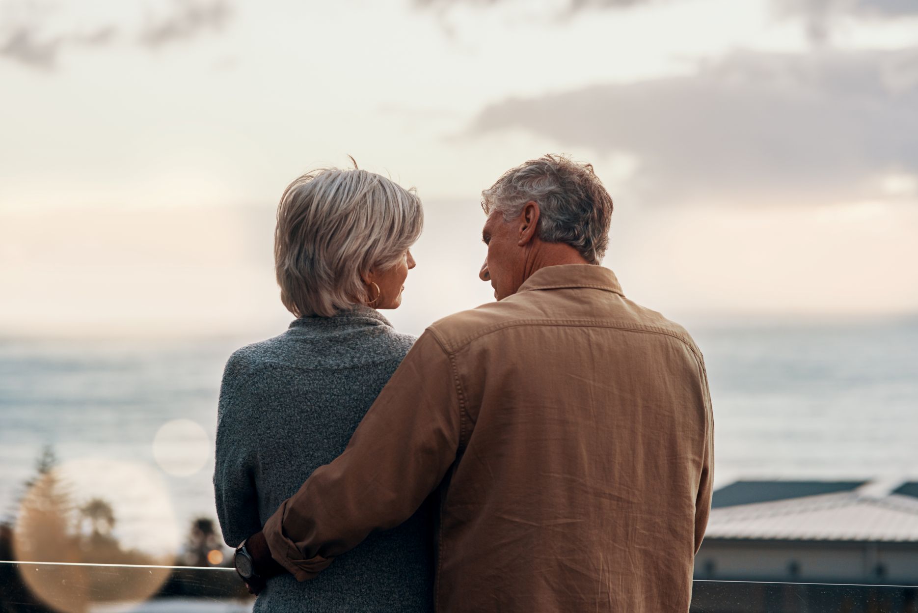 senior couple outdoor on balcony of home together